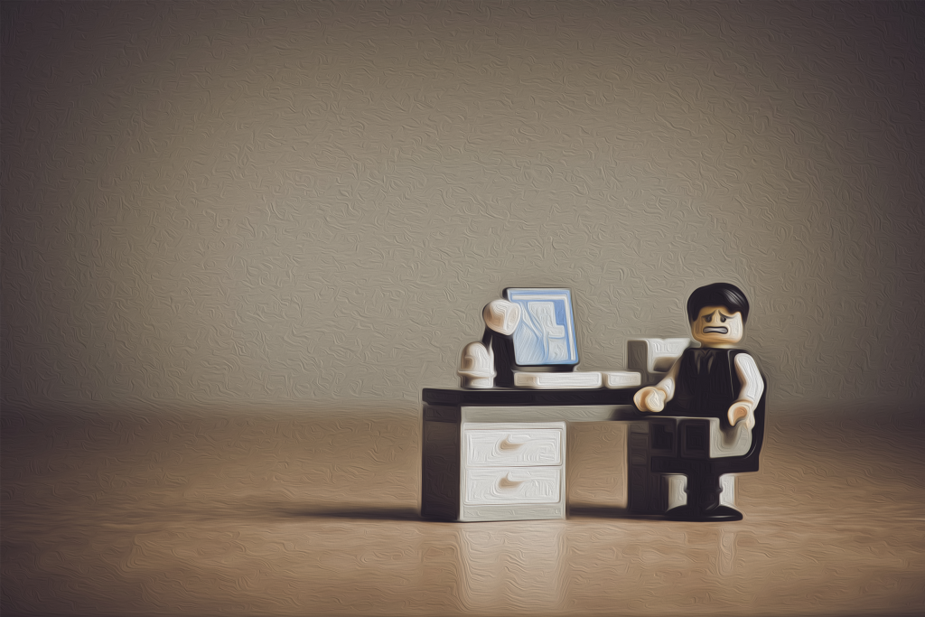 lego man in office despairing at his distraction and stress